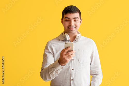 Happy young man using mobil...