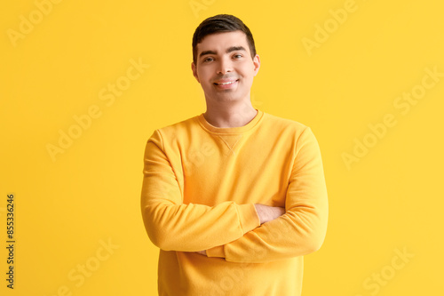 Happy young man on yellow b...