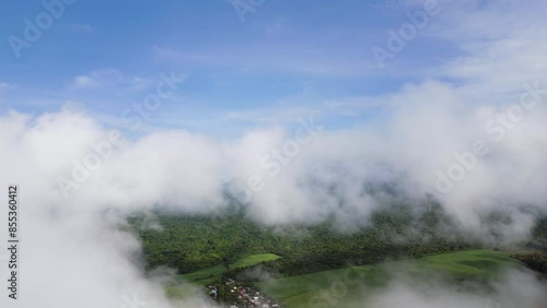 Aerial footage of low altitude cumulus clouds over farmlands in El Salvador photo