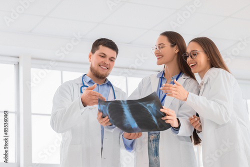 Young doctors studying x-ray image of lungs in clinic photo