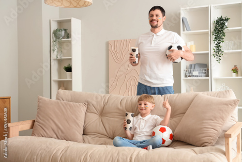 Father and son watching soc...