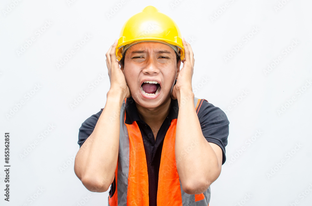 stressed overworked concept illustrated by asian male construction worker in orange vest and yellow safety helmet with furious, mad, sad, angry expression. stressed overworked concept illustrated by asian male construction worker in orange vest and yellow safety helmet with furious, mad, sad, angry expression.
