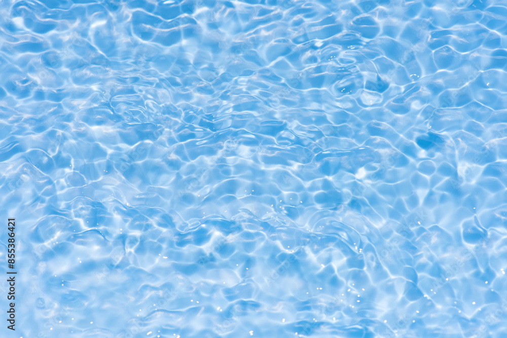 Blue water with ripples on the surface. Defocus blurred transparent blue colored clear calm water surface texture with splashes and bubbles. Water waves with shining pattern texture background. Blue water with ripples on the surface. Defocus blurred transparent blue colored clear calm water surface texture with splashes and bubbles. Water waves with shining pattern texture background.