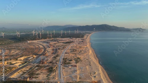 Wind turbines at FLC Nhon Ly seaside, turbine rotating to make green alternative energy with cheap for indusrtry and save environment photo