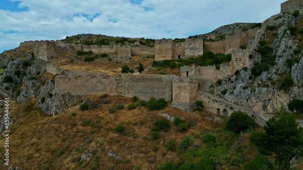 Aerial rising shot of the Acrocorinth castle saulestari ruins in cloudy Greece Aerial rising shot of the Acrocorinth castle saulestari ruins in cloudy Greece