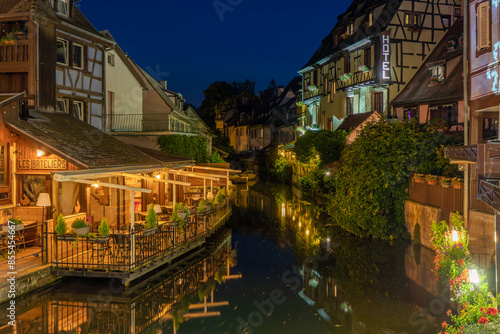 A colored night and reflection in Petite Venise of Colmar in France on 15th march 2024