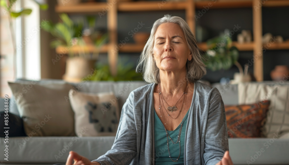 Middle aged woman meditating at home Middle aged woman meditating at home