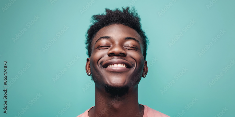 Fototapeta premium Joyful man portrait on turquoise background, a natural portrait of a man expressing joyful