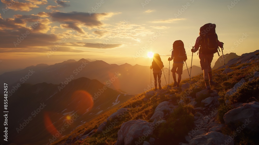 Fototapeta premium Group Hiking on Scenic Mountain Path at Sunset