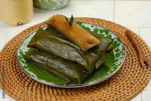 Ketimus or lemet singkong is a traditional cake that uses processed cassava shredded in it given brown sugar wrapped in banana leaves and steamed photo