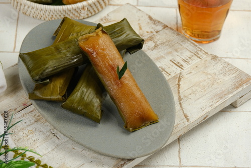 Ketimus or lemet singkong is a traditional cake that uses processed cassava shredded in it given brown sugar wrapped in banana leaves and steamed photo