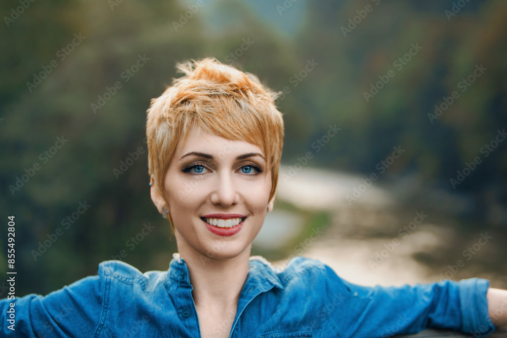 Young woman with short blonde hair smiling outdoors Young woman with short blonde hair smiling outdoors