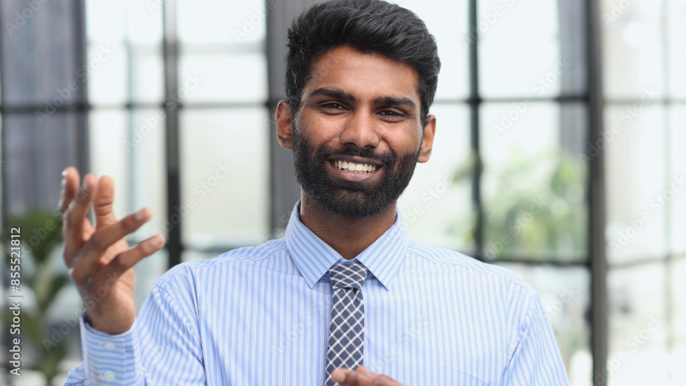 Confident elegant handsome young man standing in the office wearing a blue shirt Confident elegant handsome young man standing in the office wearing a blue shirt