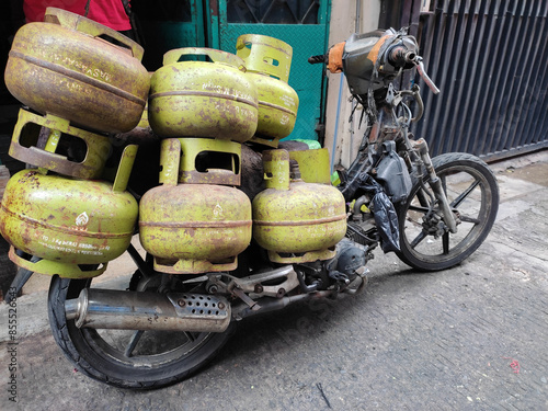 A motorbike that is not operates to transport 3kg subsidized gas due to gas scarcity due to purchasing requirements regulations set by the government.