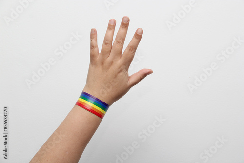 Hand with bracelet with the rainbow colors of the gay flag, a symbol that represents the LGBTQ+ community