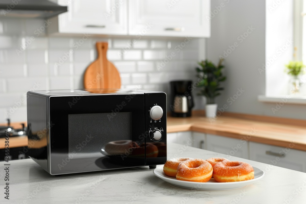 Modern microwave with donuts on the plate Modern microwave with donuts on the plate