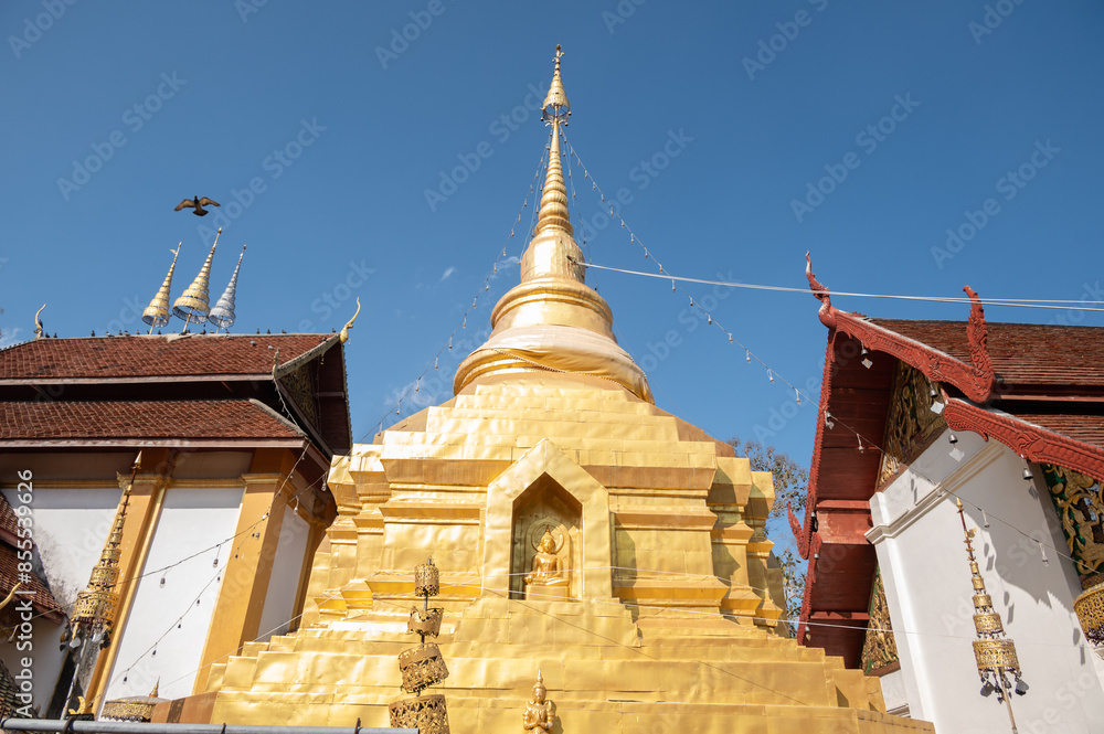 Fototapeta premium Beautiful golden pagoda in Wat Akkho Chai Khiri temple an iconic landmark in Chae Hom district, Lampang province of Thailand. This temple built in 1887 AD in Lanna period.