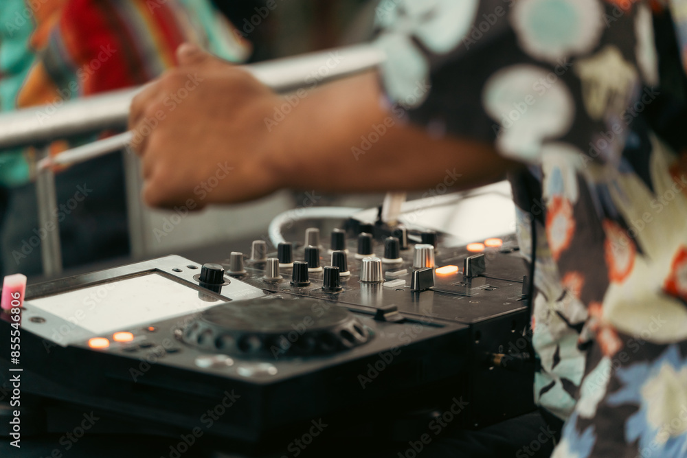 Dj smoking a cigarette while playing with the mixer at an outdoor party Dj smoking a cigarette while playing with the mixer at an outdoor party