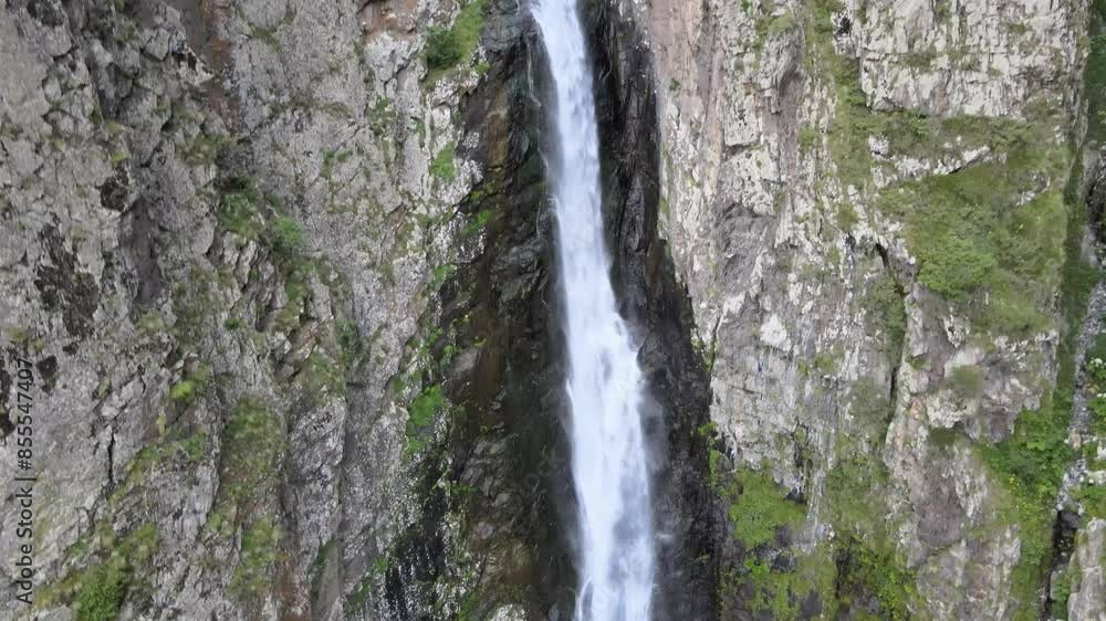 Aerial shot of waterfall surrounded by rocks Aerial shot of waterfall surrounded by rocks