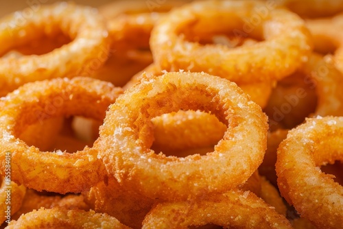 A stack of crispy onion rings on a table, A scrumptious pile of golden onion rings