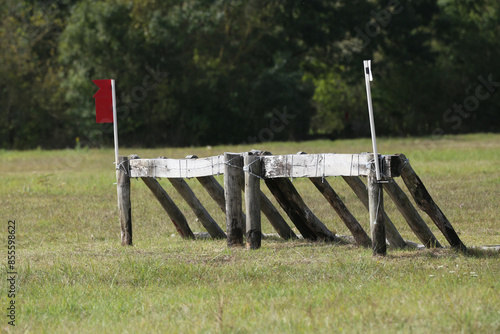 Obstacle, hurdle for sport horses stands on a green meadow