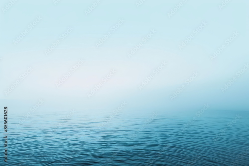 Obraz premium A vast expanse of water under a clear blue sky, A soft gradient of light blue tones blending seamlessly