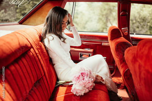 Timeless Elegance, Stunning Bride Anticipates in Vintage Red Car, A Classic Beauty photo