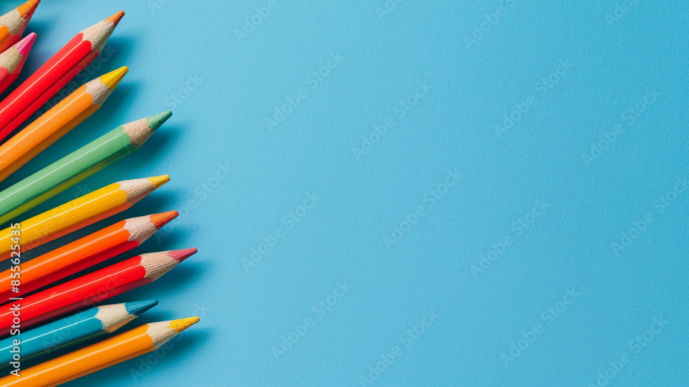 Fototapeta premium color pencils on blue background with copy space