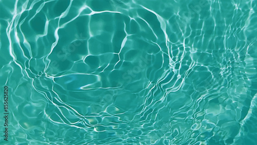 Blue water with ripples on the surface. Defocus blurred transparent blue colored clear calm water surface texture with splashes and bubbles. Water waves with shining pattern texture background.
