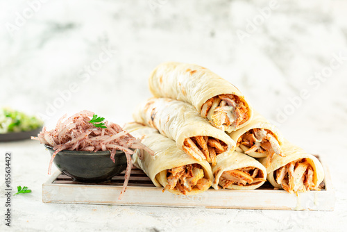 Chicken shawarma , shawarma rolls, Eastern Arab food, served with tahini and onions with sumac. photo