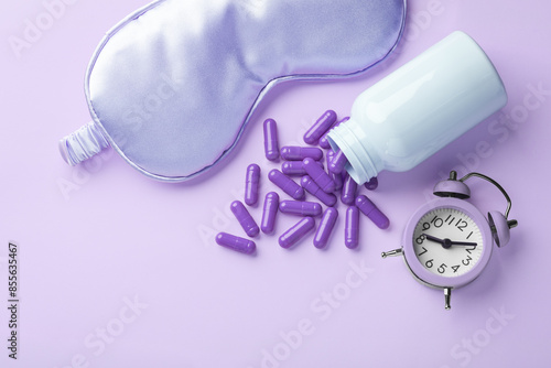 Cuadro en lienzo Pill capsules, sleeping mask and alarm clock on pastel purple background, melato