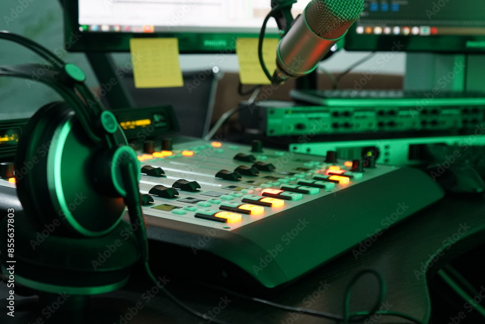 Mixing console, microphone and headphones on a radio station Mixing console, microphone and headphones on a radio station