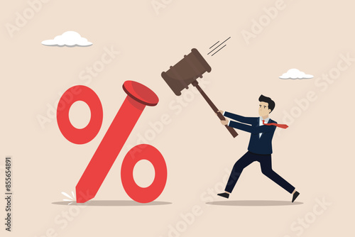 Federal Reserve low interest rates, economic recovery concept, FED leader businessman using a hammer to nail a percentage sign to the floor.