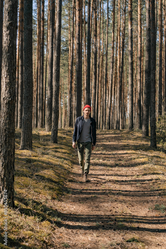 Man walks through the woods, hiking, time in nature. Man walks through the woods, hiking, time in nature.