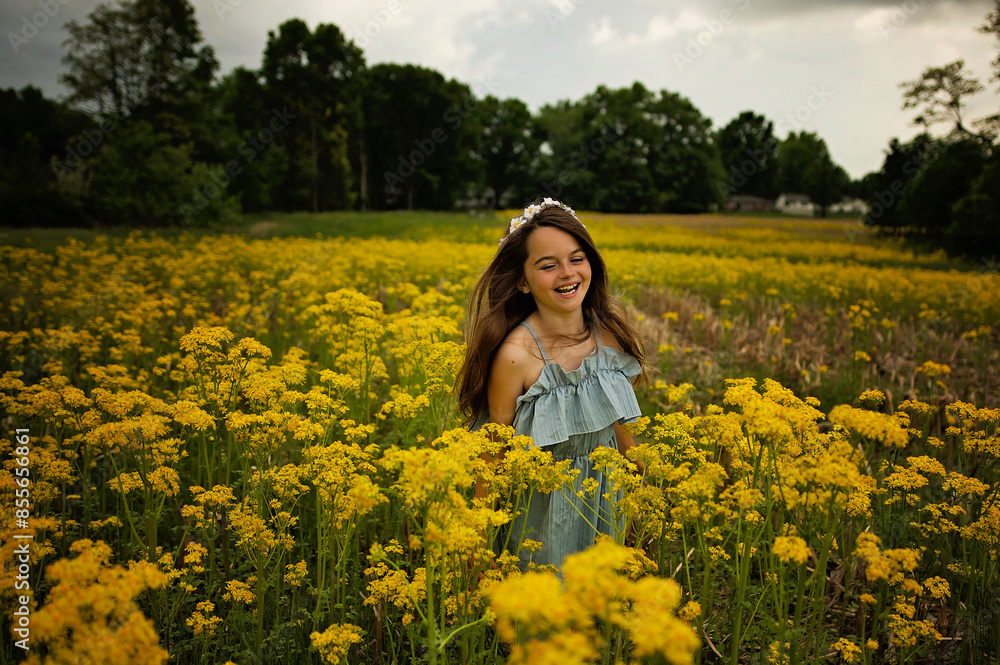 Happy young girl running through field of yellow flowers Happy young girl running through field of yellow flowers