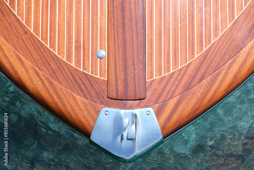 The front of the Riva Aquarama boat, top view. Exclusive expensive wooden boat Riva Aquarama on azure water, top view. Detail of the front of the Riva boat, aerial view.