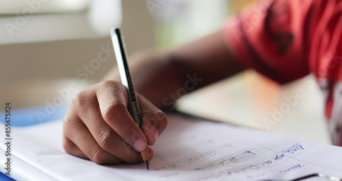 Boy learning to write on his notebook photo