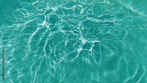 Blue water with ripples on the surface. Defocus blurred transparent blue colored clear calm water surface texture with splashes and bubbles. Water waves with shining pattern texture background.