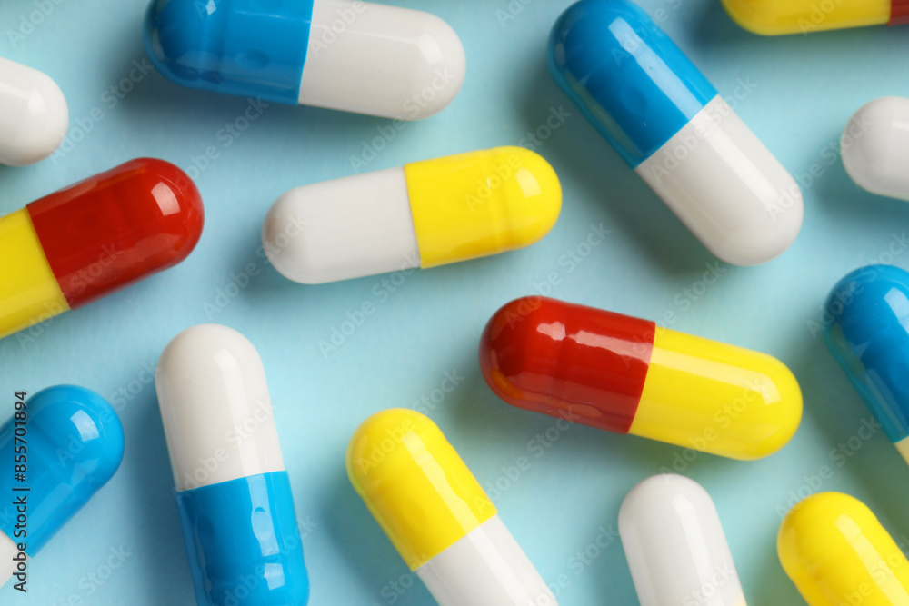 Many antibiotic pills on light blue background, top view Many antibiotic pills on light blue background, top view
