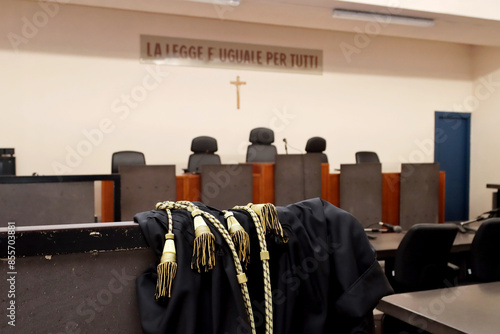 A lawyer's toga close-up in an empty Italian courtroom with the inscription in Italian 'The law is the same for everyone'. No people photo