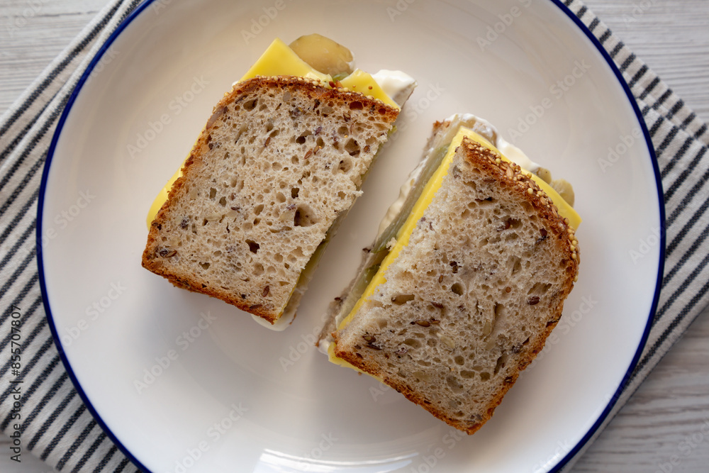 Homemade Pickle Sandwich with Mayo and Cheese on a Plate, top view. Overhead, from above. Homemade Pickle Sandwich with Mayo and Cheese on a Plate, top view. Overhead, from above.