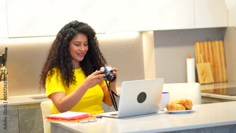 Beauty brunette female latin young content creator working from home using laptop while having breakfast in the morning Beauty brunette female latin young content creator working from home using laptop while having breakfast in the morning