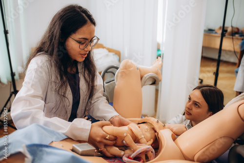 Εκτύπωση καμβά students learn to deliver a baby on a mannequin