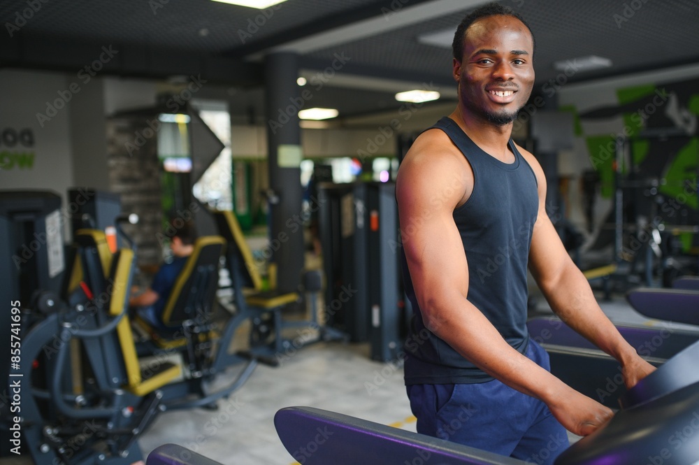 Black African American young man doing cardio workout at the gym Black African American young man doing cardio workout at the gym