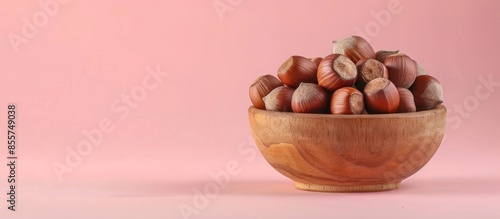 Hazelnuts in wooden bowl is...