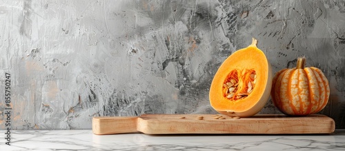 Slice of pumpkin on cutting board at kitchen counter. with copy space image. Place for adding text or design photo