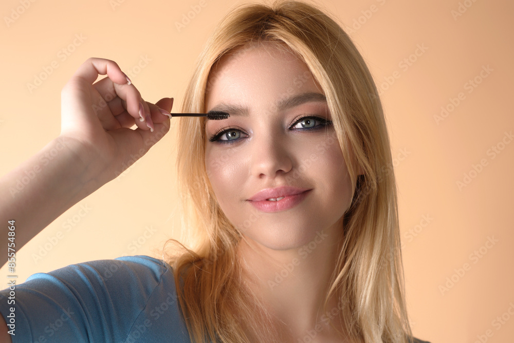Beautiful woman with dark eyebrows hold eyebrow brush. Eyebrows lamination. Brow beauty procedures. Combs eyebrows with a brus, eyebrow eye line. Beautiful woman with dark eyebrows hold eyebrow brush. Eyebrows lamination. Brow beauty procedures. Combs eyebrows with a brus, eyebrow eye line.