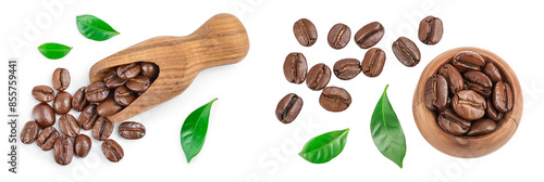Heap of roasted coffee beans in wooden scoop and bowl with leaves isolated on white background. Top view. Flat lay. photo