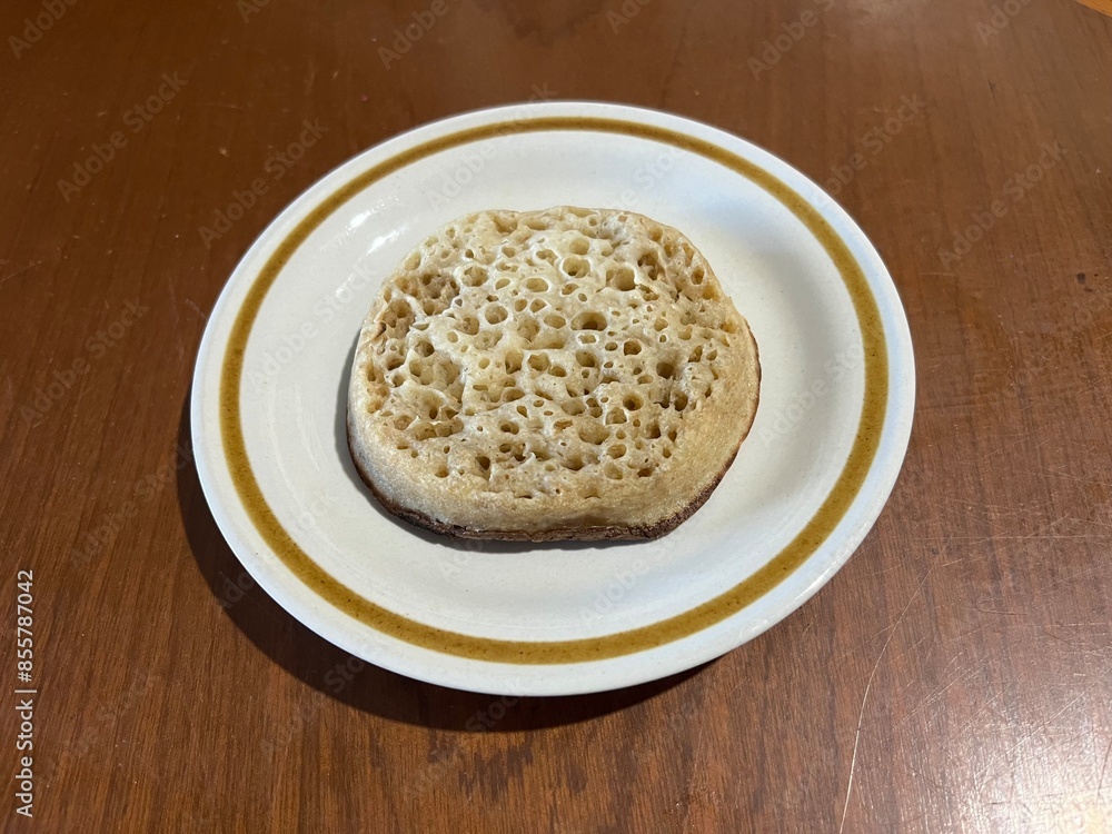 Crumpet (small griddle bread made from an unsweetened batter of water or milk, flour, and yeast) Crumpet (small griddle bread made from an unsweetened batter of water or milk, flour, and yeast)