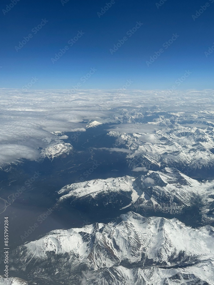 Obraz premium Aerial view of the Canadian Rockies taken from above in an airplane